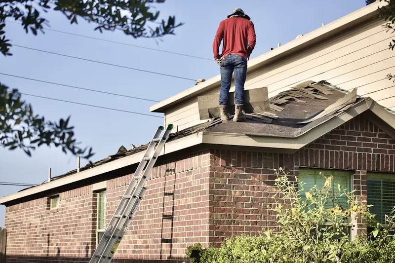 Professional roofer working on a residential roof in Finksburg